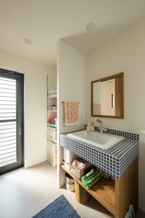 アクセントタイルと木の縁がかわいい洗面台　