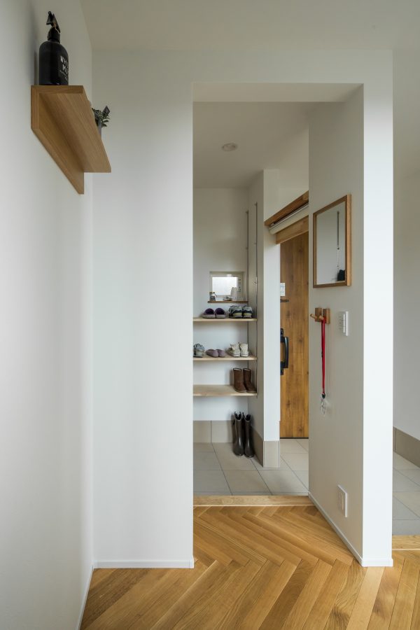 ロールスクリーンで隠せるシンプルな棚のあるシューズクローク　