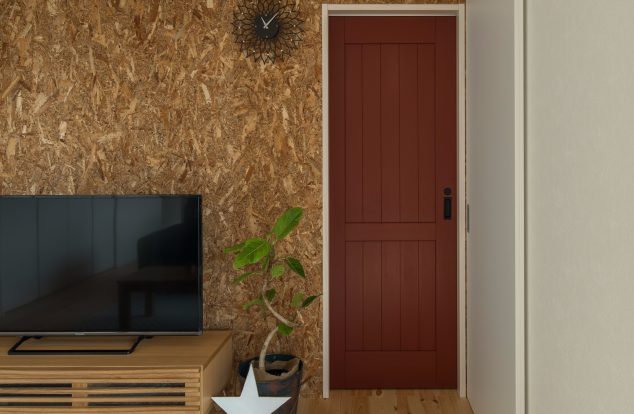 テレビボード後ろのコルクの壁が印象的なリビング　